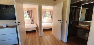 Фото номера Шале с двумя спальнями Дома для отпуска Lumi Resort Domki letniskowe г. Реваль 15